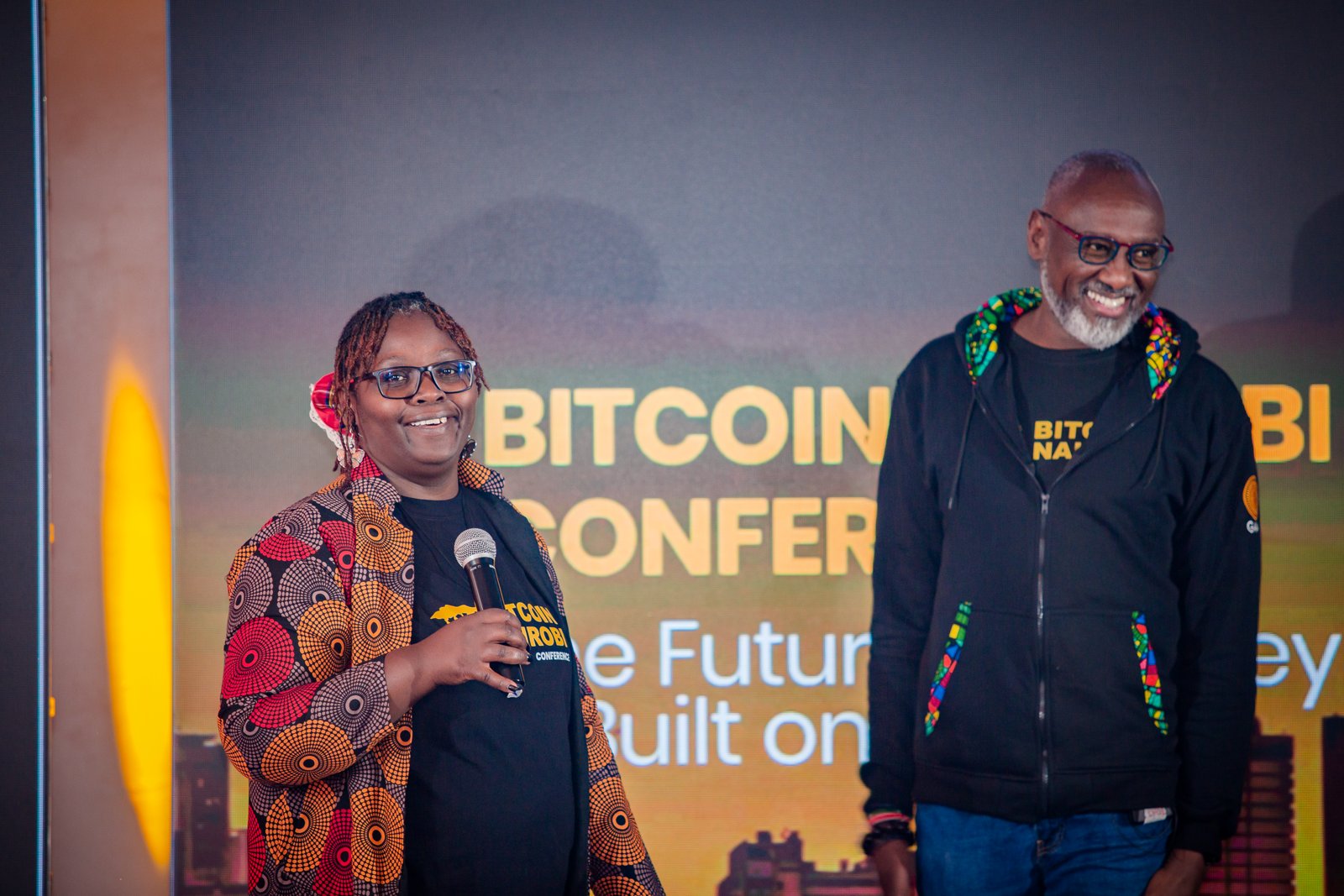 A speaker on the main stage of the Bitcoin Nairobi Conference under a backdrop reading 'The Future of Money, Built on Bitcoin'